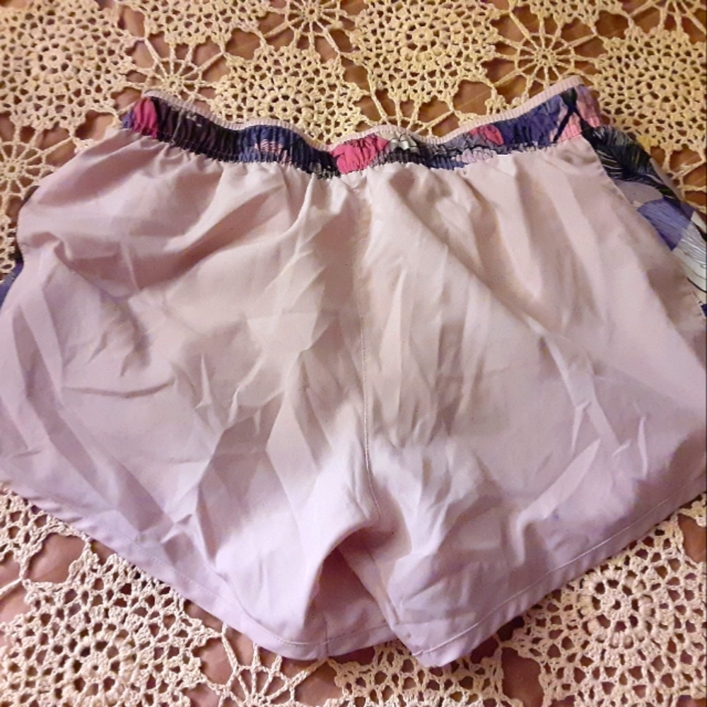 Nike shorts for runners. Pink with pattern on the side. They are a size medium.